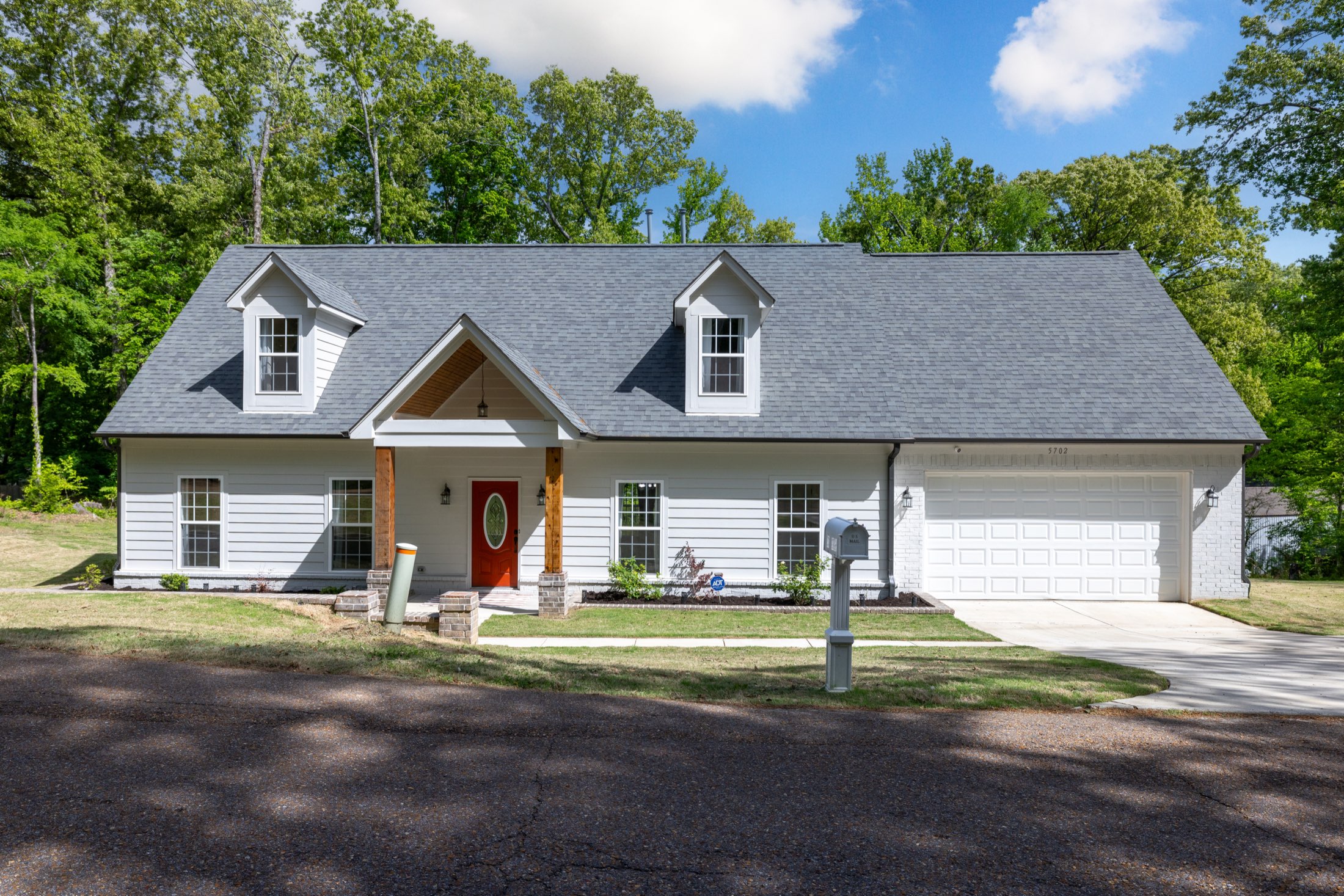 White cape-style home in Bartlett with a covered porch
