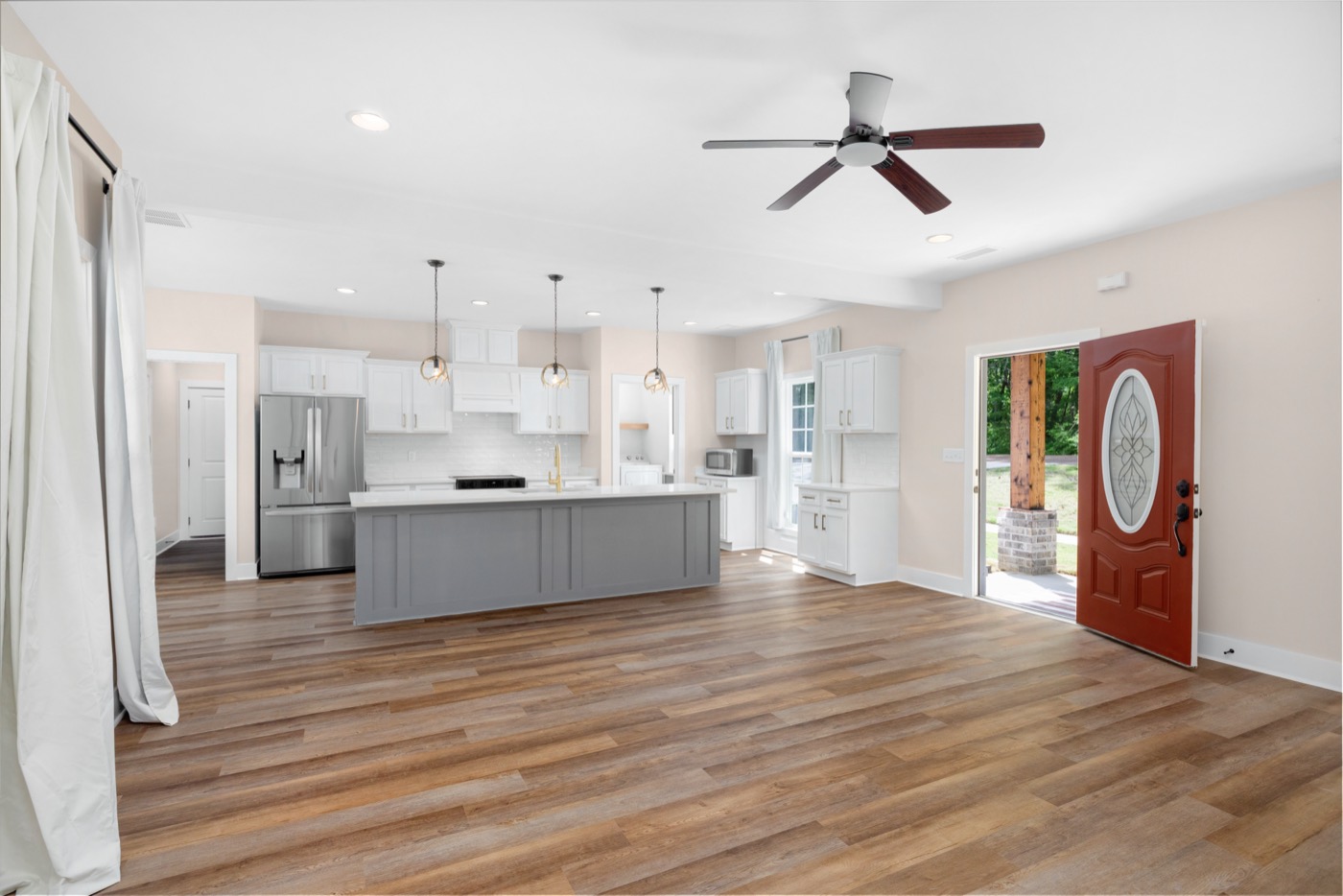 Open living room and kitchen with wood-look floors